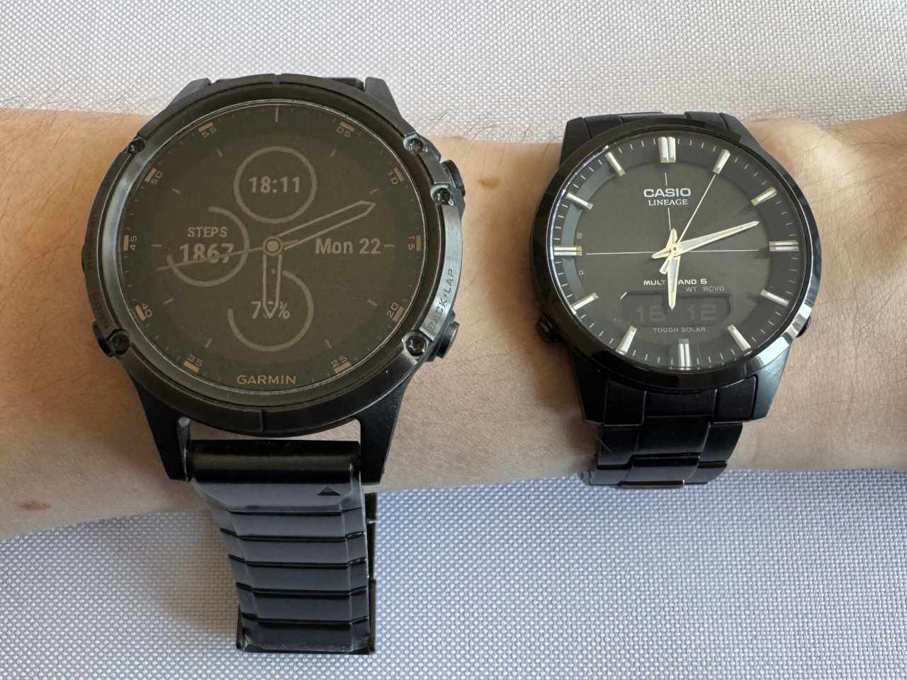 Garmin fēnix 5 Plus next to Casio LCW M170DB-1Aer